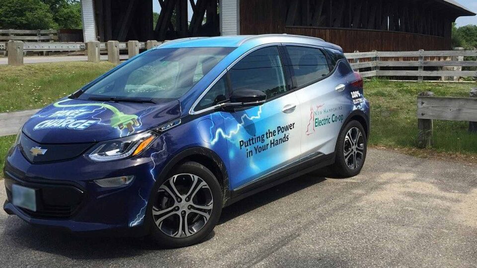 Electric New Hampshire Electric Cooperative branded car parked in a parking spot outside during the day