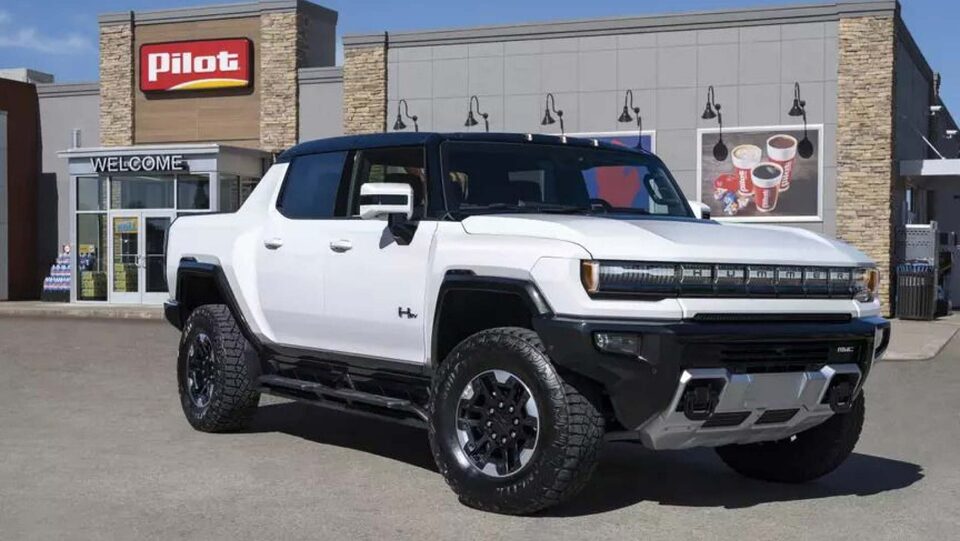 White Hummer EV in front of Pilot gas station.