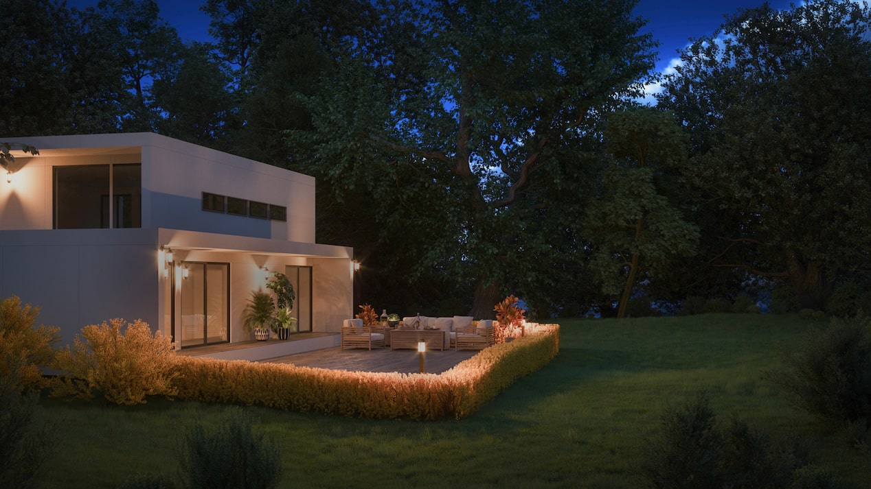 A modern home at night with outdoor lighting