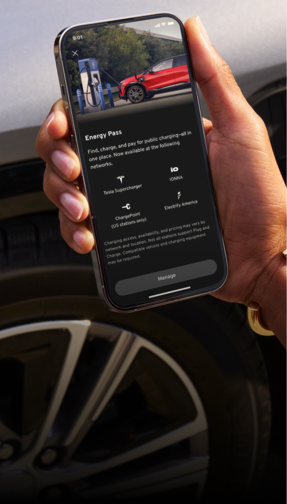 Hand holds phone showing GM EV with Energy Pass in the GM vehicle mobile app