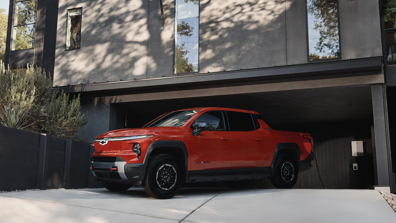 Man in garage with EV truck with the GM Energy product suite