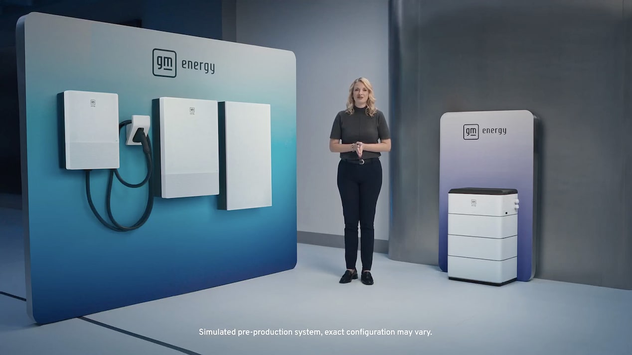 A spokesperson standing in front of a full suite of GM Energy products 