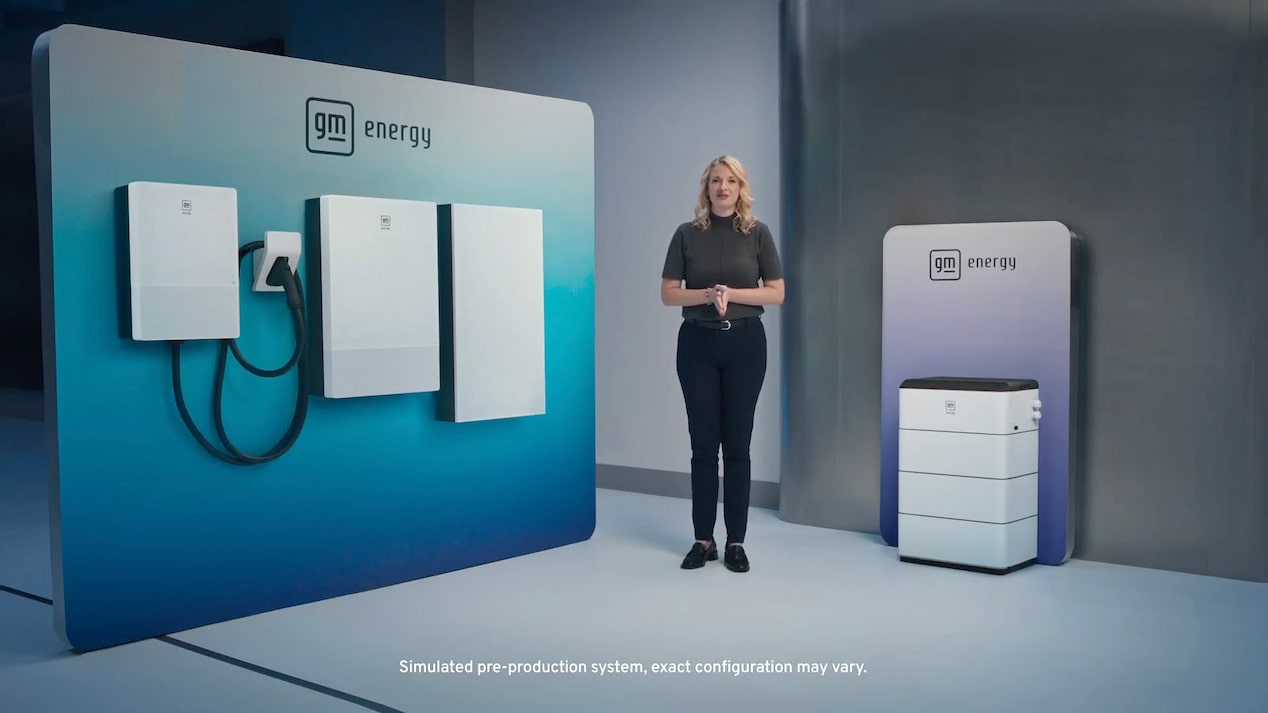 A spokesperson standing in front of a full suite of GM Energy products 