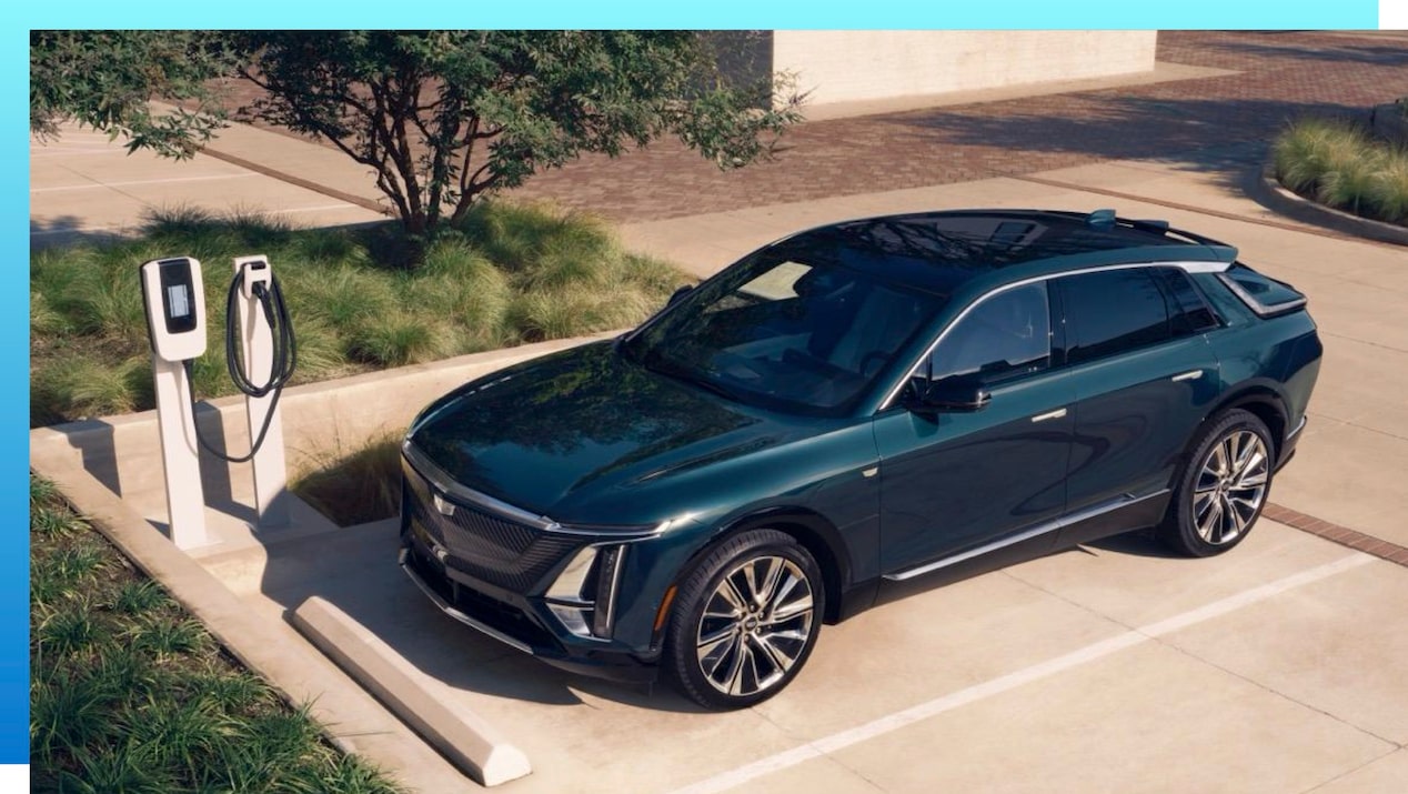 A Cadillac LYRIQ parked at charging equipment.