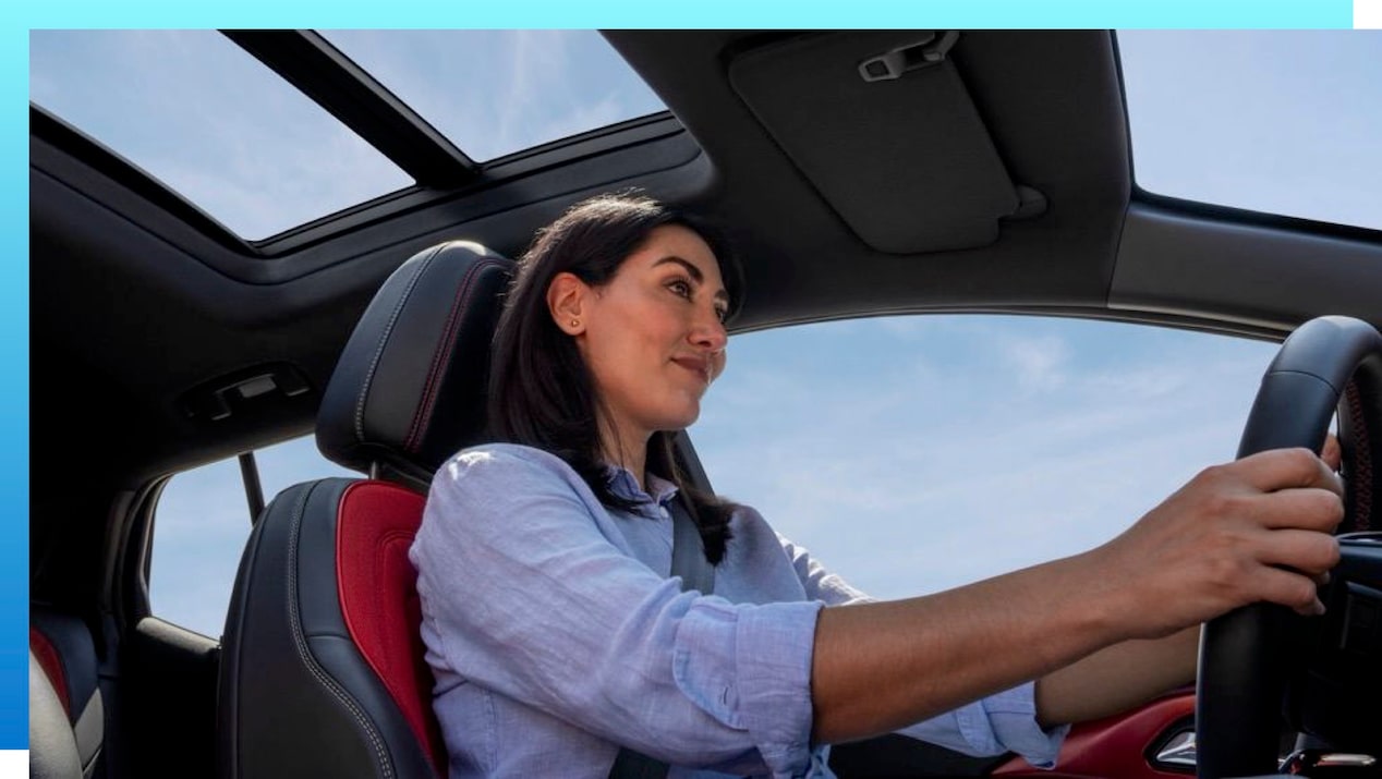 A woman driving a GM Electric Vehicle.