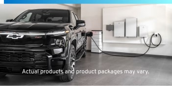 Black EV plugged into wall charging station