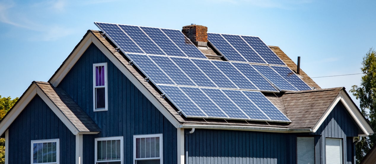 Modern blue house equipped with solar panels