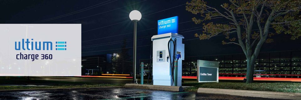 An Ultium Charge 360 station near a streetlight at night with the Ultium Charge 360 logo over the left side of the image.